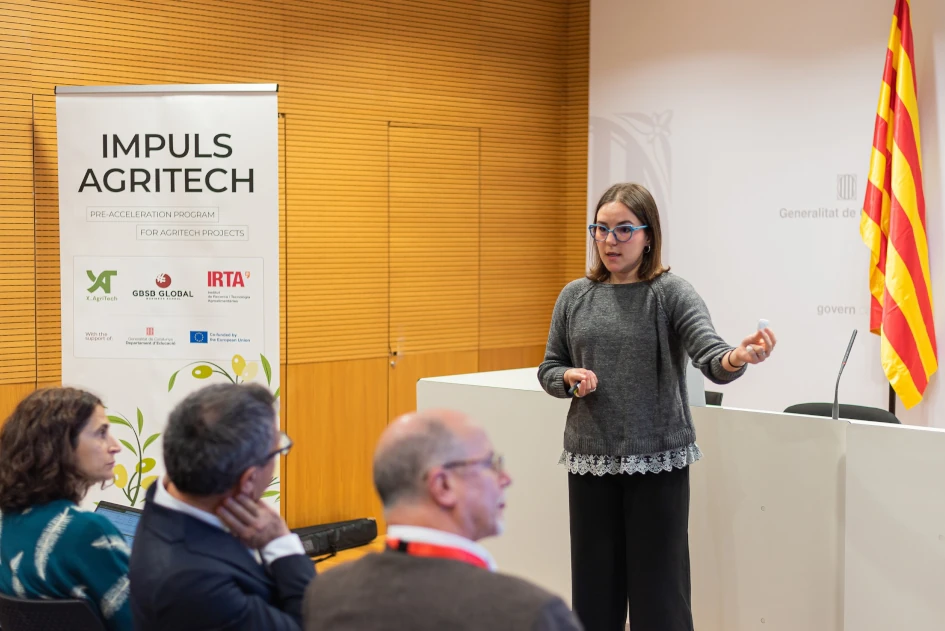 Pitch presentation at Impuls AgriTech 2025 Demo Day with partner logos from IRTA, GBSB Global and the Catalan Government